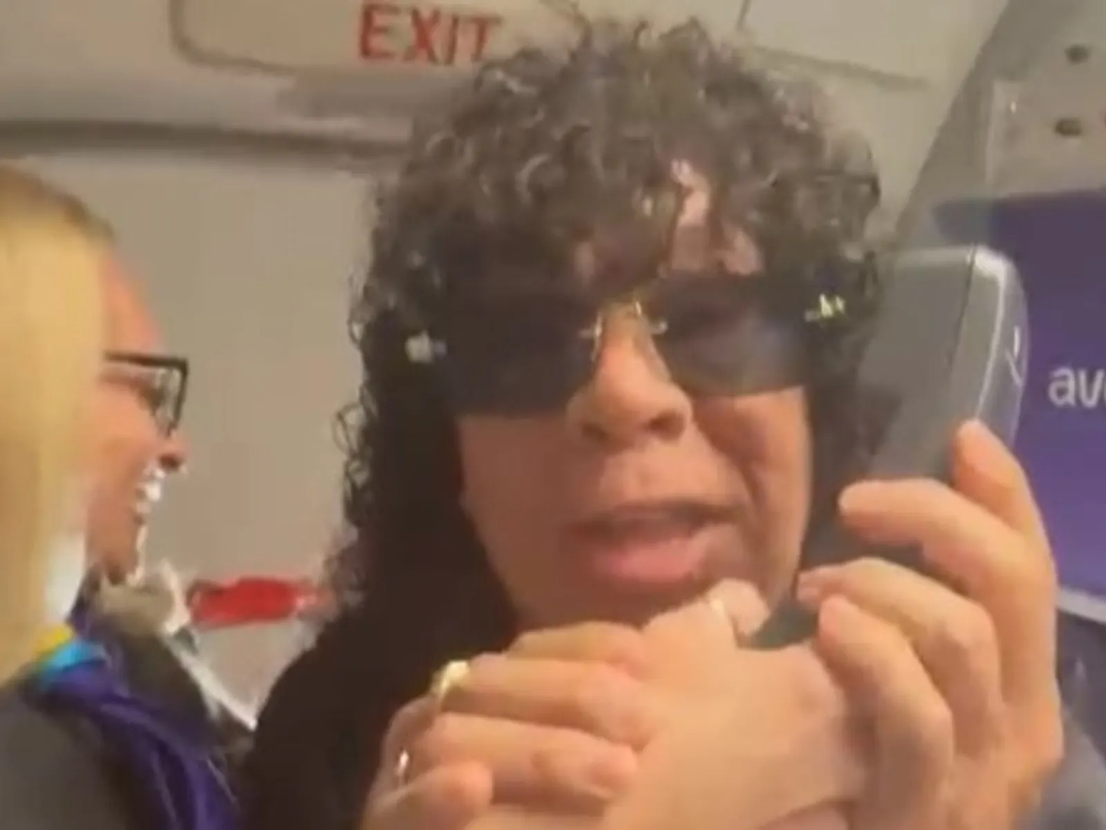 Carlos "La Mona" Jiménez cantando en el pasillo de un avión para pasajeros que viajan a alentar a la Selección Argentina.