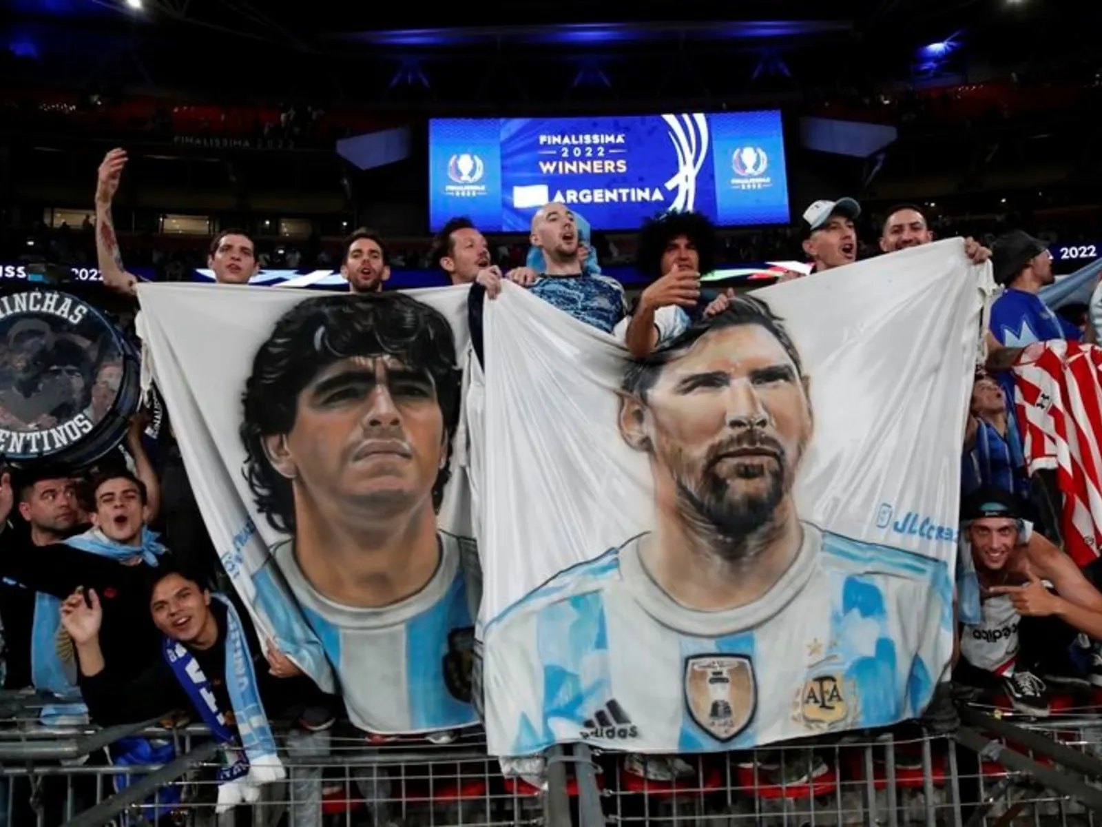 Vista de un estadio de fútbol durante un partido entre las selecciones de Argentina e Inglaterra, con banderas de ambos países.
