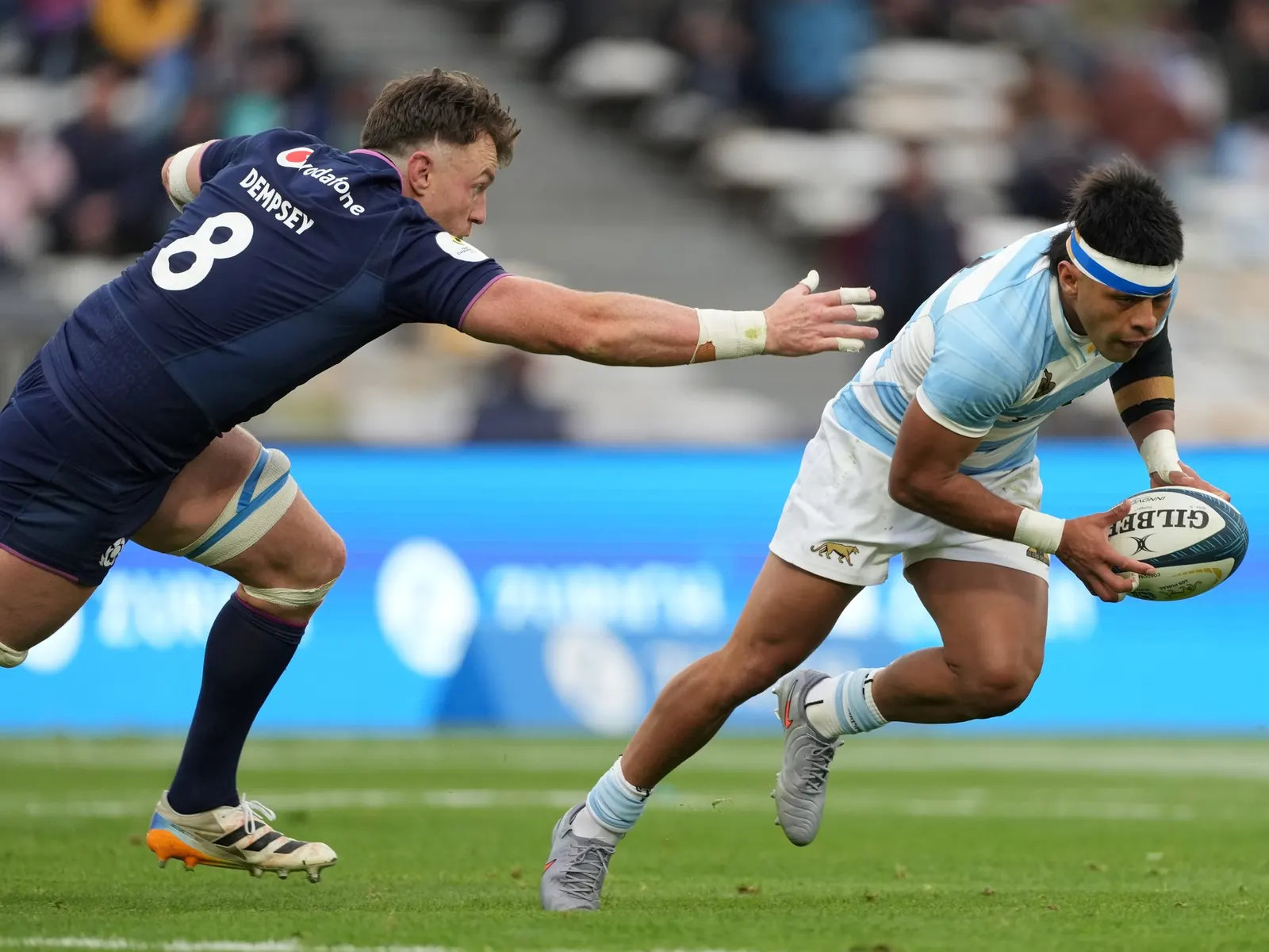 Jugadores de Los Pumas celebrando un try durante un partido.